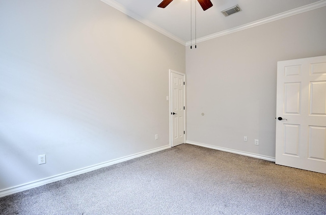 carpeted empty room featuring ceiling fan and crown molding