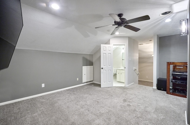 additional living space featuring lofted ceiling, ceiling fan, and carpet