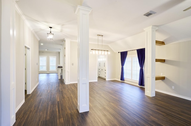 unfurnished living room featuring ornamental molding, dark wood-type flooring, an inviting chandelier, and lofted ceiling