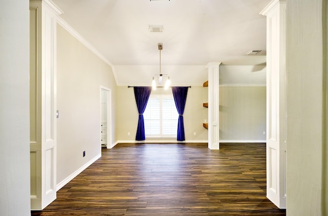 empty room featuring dark wood-type flooring, vaulted ceiling, and crown molding