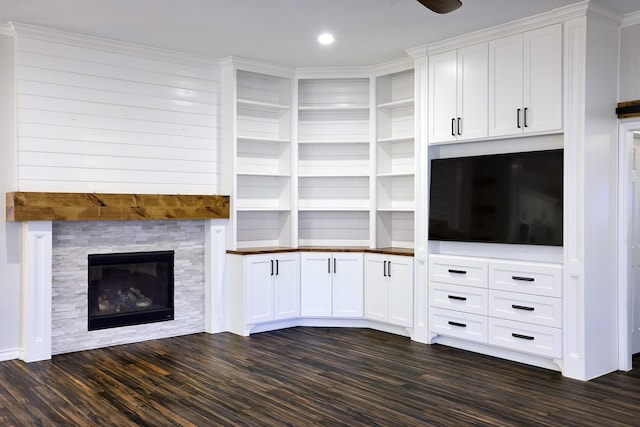 unfurnished living room with dark wood-type flooring and a fireplace