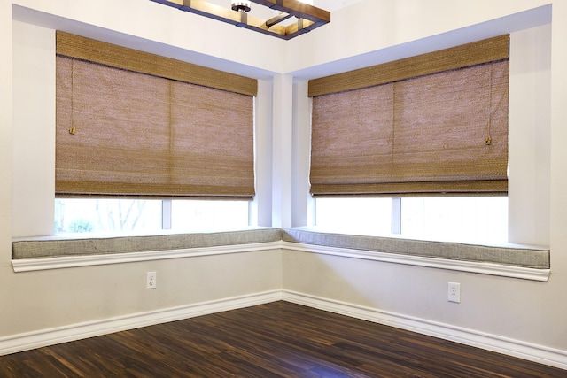 spare room with dark wood-type flooring