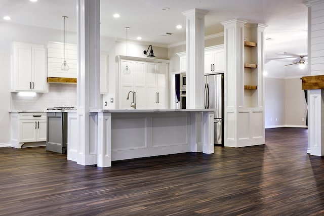 kitchen with white cabinets, ceiling fan, hanging light fixtures, and stainless steel appliances