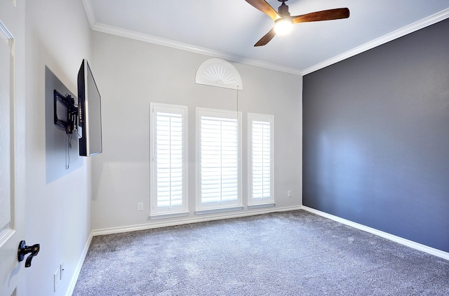 carpeted spare room with ceiling fan and crown molding