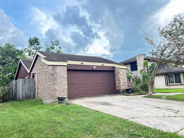 view of side of home featuring a garage and a lawn