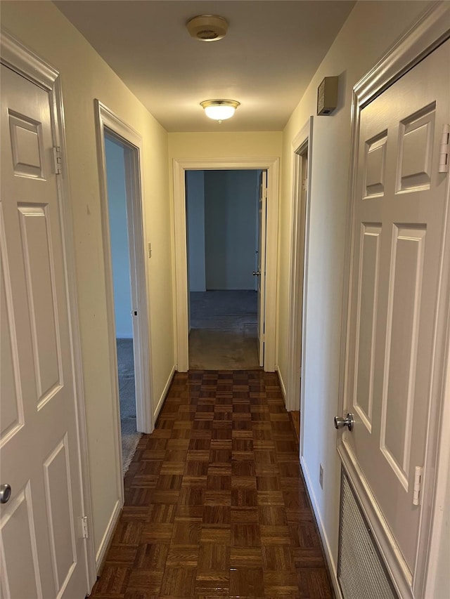 hallway with dark parquet flooring