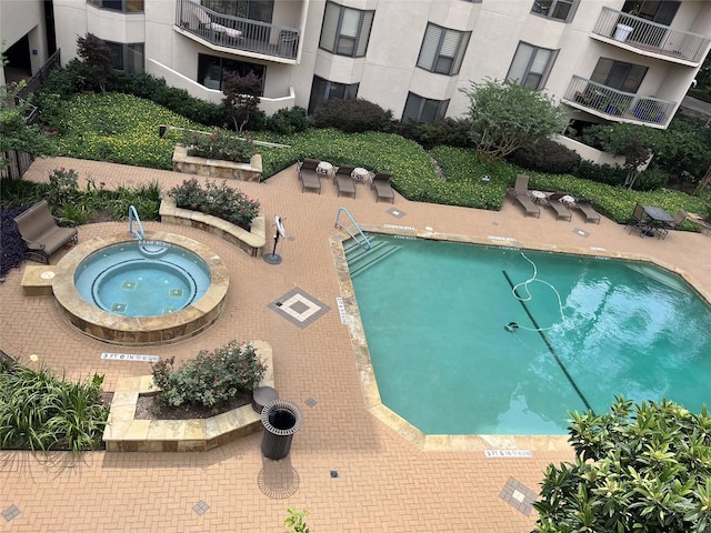 view of pool with a community hot tub