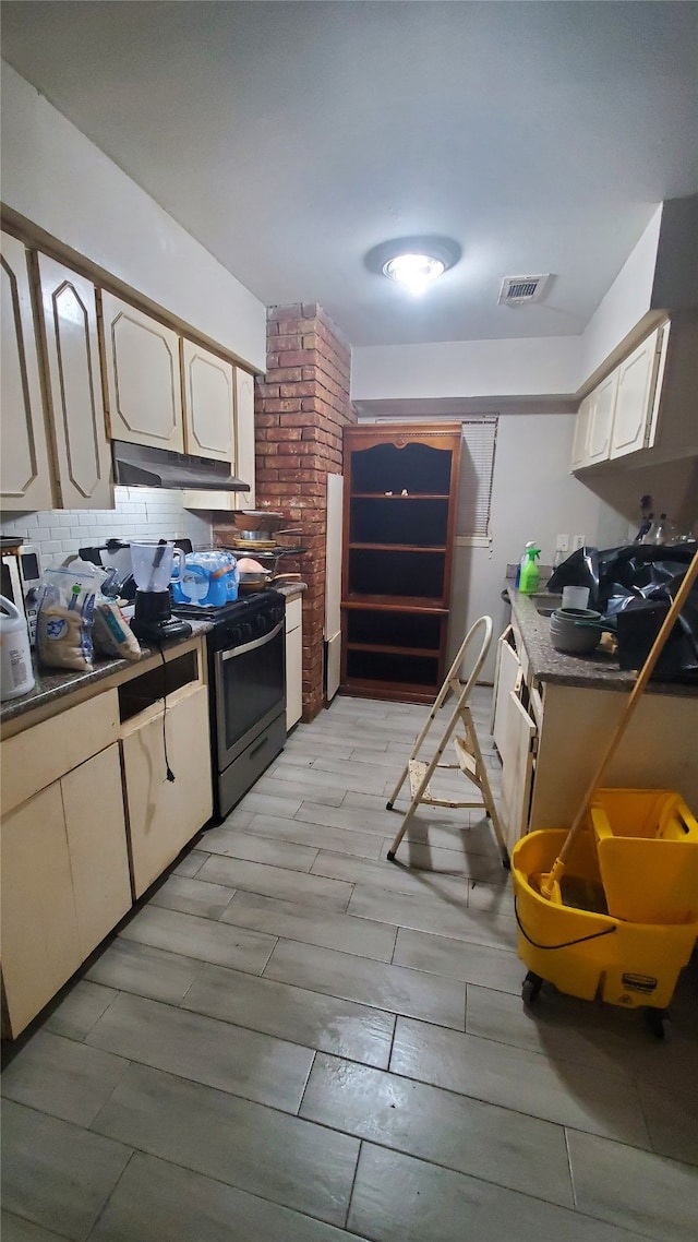 kitchen with tasteful backsplash and stainless steel range oven