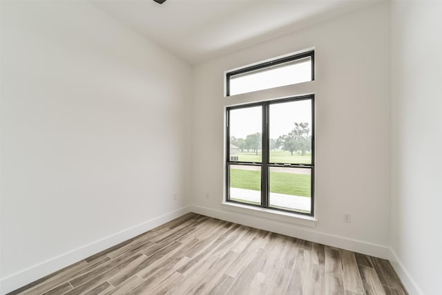 unfurnished room with light wood-type flooring