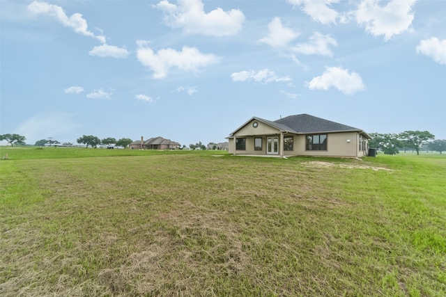 exterior space featuring a rural view and a front lawn