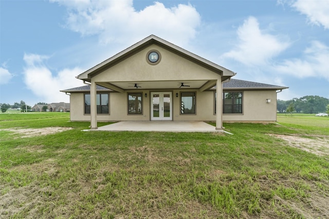 rear view of property with french doors, a yard, ceiling fan, and a patio