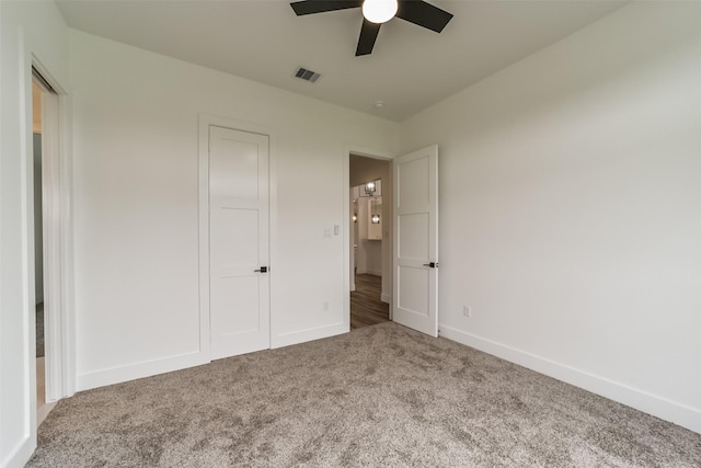 unfurnished bedroom featuring ceiling fan and carpet flooring