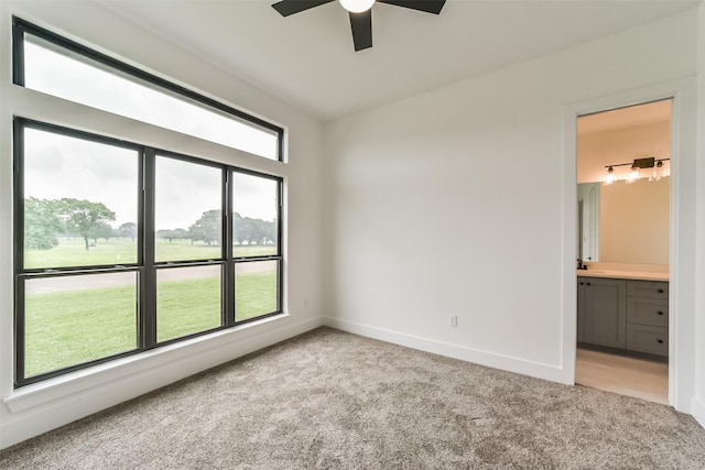 carpeted spare room with ceiling fan