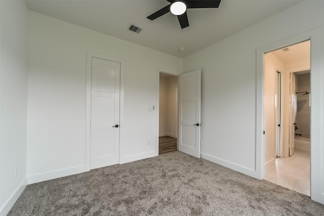 unfurnished bedroom featuring ceiling fan and carpet floors