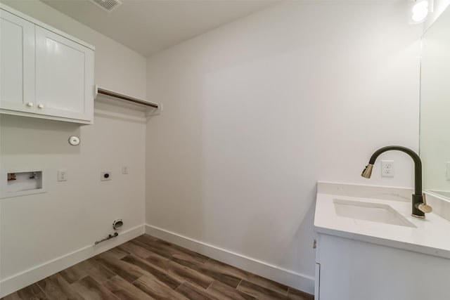 laundry room featuring sink, washer hookup, cabinets, hookup for an electric dryer, and hookup for a gas dryer