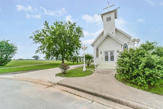 exterior space with a front yard and french doors