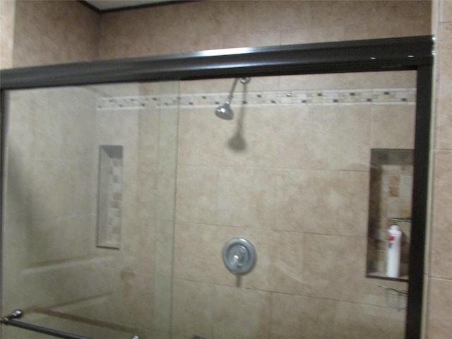 bathroom with a tile shower