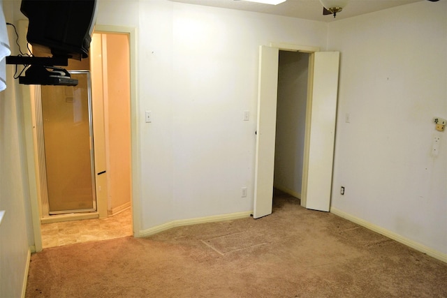 unfurnished room featuring light colored carpet