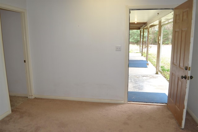 entryway featuring light colored carpet