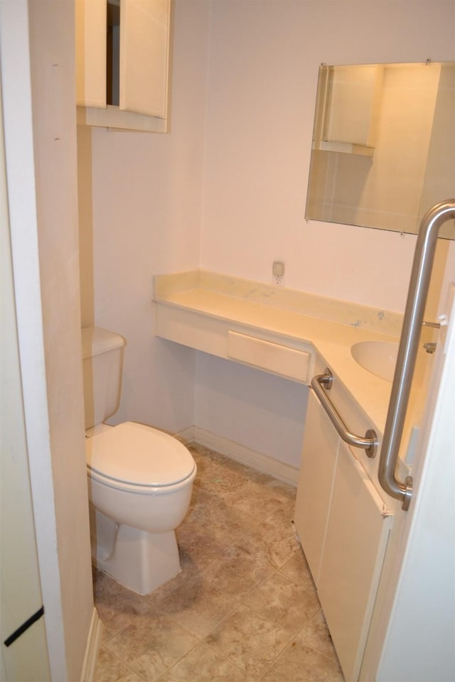 bathroom featuring toilet and vanity