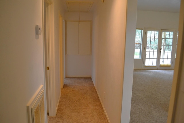 hall with light carpet and french doors