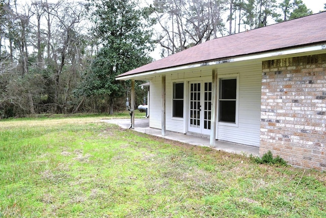 view of yard with a patio area and french doors