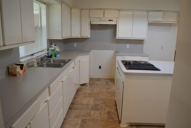 kitchen featuring sink, black electric stovetop, and white cabinetry