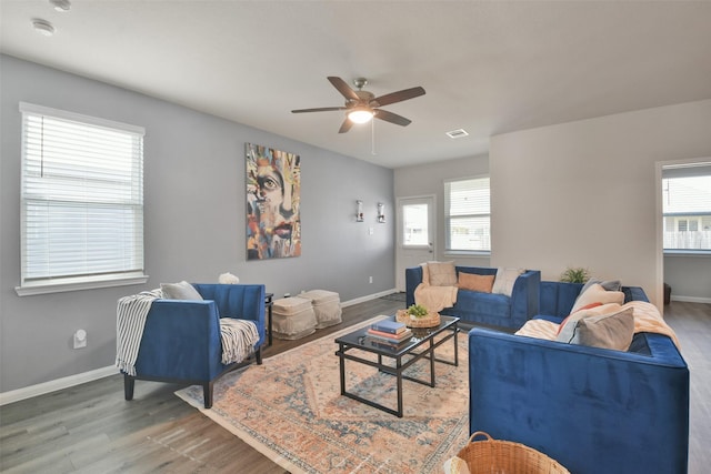 living room with ceiling fan, a wealth of natural light, and wood-type flooring