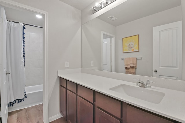 bathroom with vanity, shower / bath combination with curtain, and hardwood / wood-style flooring