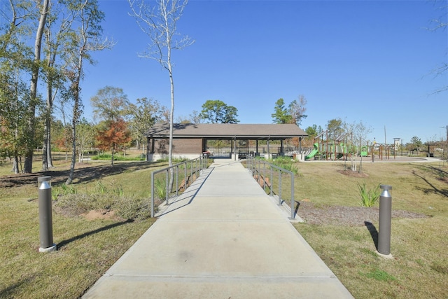 view of home's community with a playground and a lawn