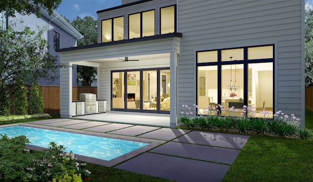 back of property with fence, a ceiling fan, a patio, area for grilling, and an outdoor pool