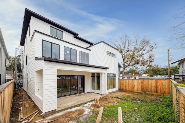 back of property with a patio