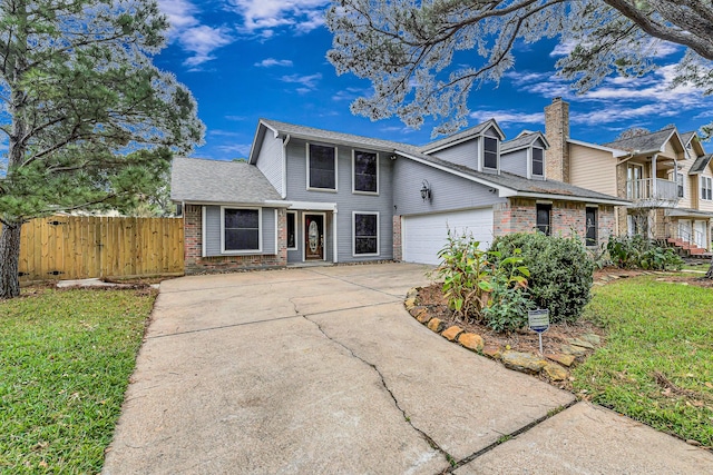 view of front of property with a front yard and a garage