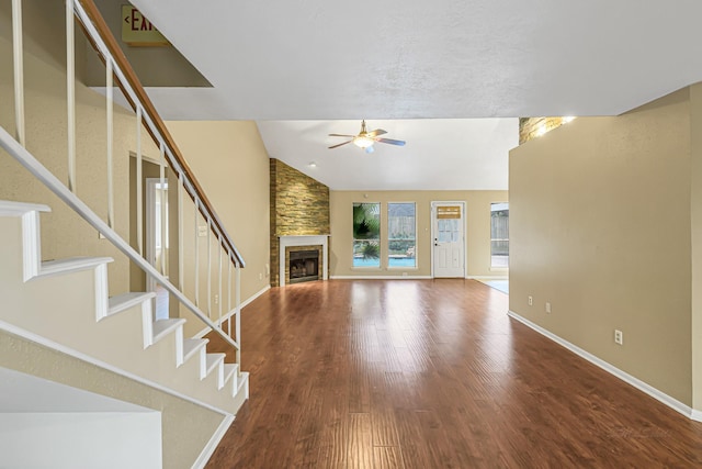 unfurnished living room with vaulted ceiling, a fireplace, ceiling fan, and hardwood / wood-style flooring