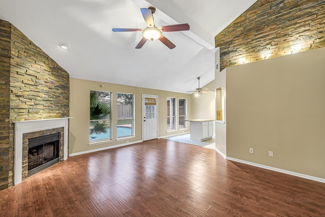 unfurnished living room featuring ceiling fan, vaulted ceiling, light hardwood / wood-style flooring, and a stone fireplace