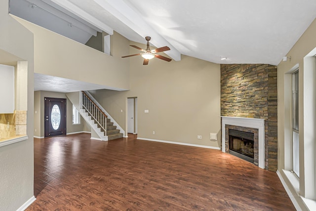 unfurnished living room with a fireplace, lofted ceiling with beams, ceiling fan, and dark hardwood / wood-style floors