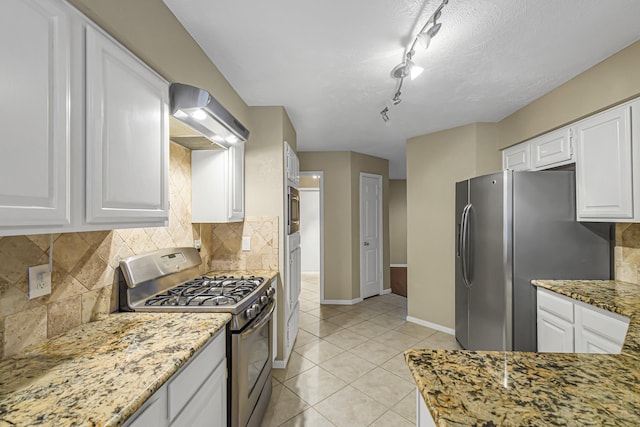 kitchen with stainless steel appliances, rail lighting, stone countertops, white cabinetry, and ventilation hood