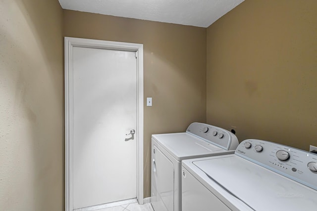 washroom with light tile patterned flooring and independent washer and dryer