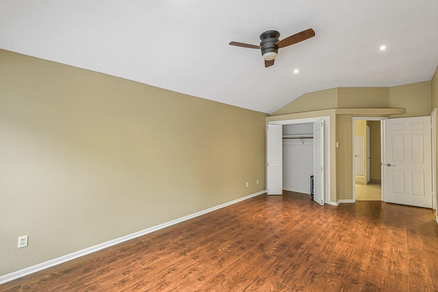 unfurnished bedroom featuring dark hardwood / wood-style flooring, a closet, ceiling fan, and vaulted ceiling