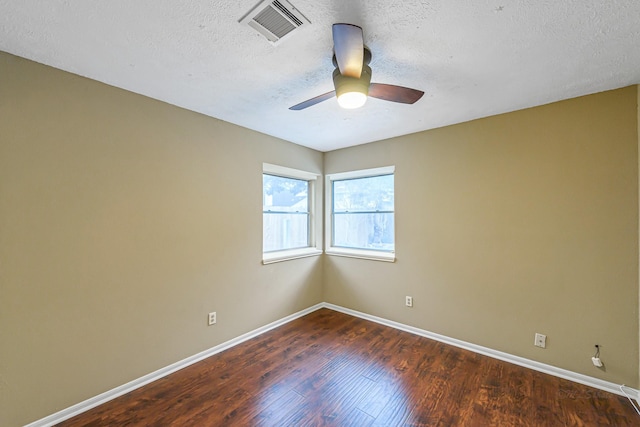 unfurnished room with a textured ceiling, ceiling fan, and dark hardwood / wood-style flooring