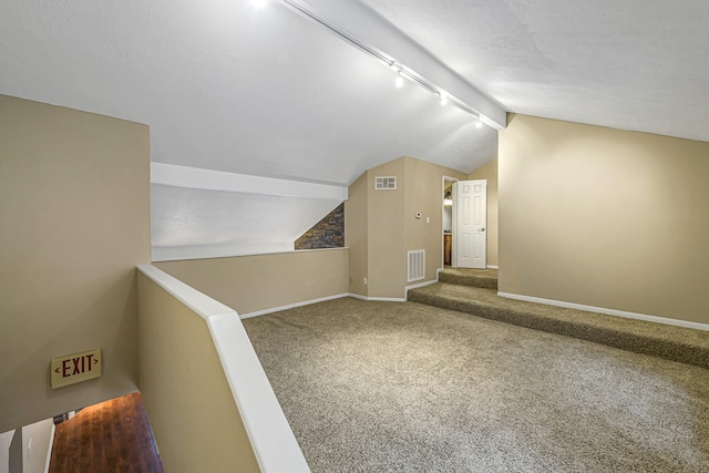 bonus room with lofted ceiling and carpet floors