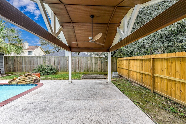 view of patio featuring ceiling fan and a fenced in pool