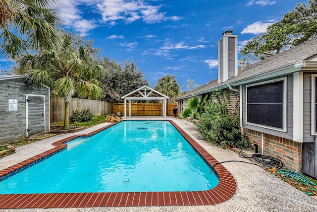 view of pool with a gazebo and a storage shed