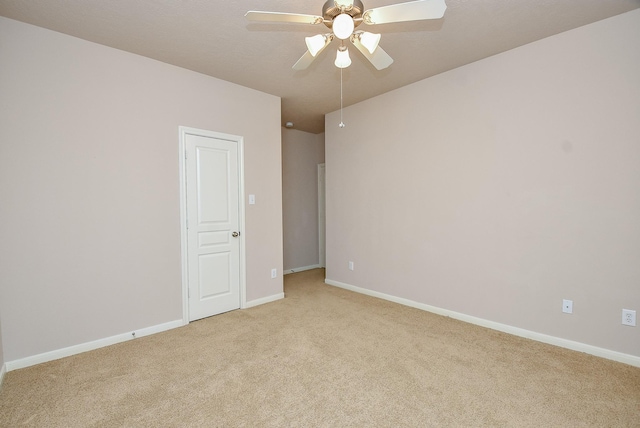 carpeted empty room featuring ceiling fan