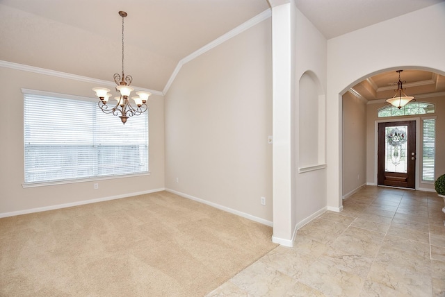 carpeted foyer entrance featuring vaulted ceiling, crown molding, and an inviting chandelier