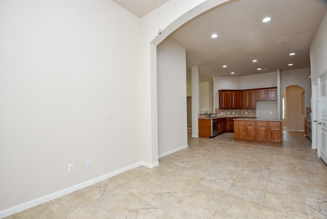 kitchen featuring backsplash and stainless steel dishwasher