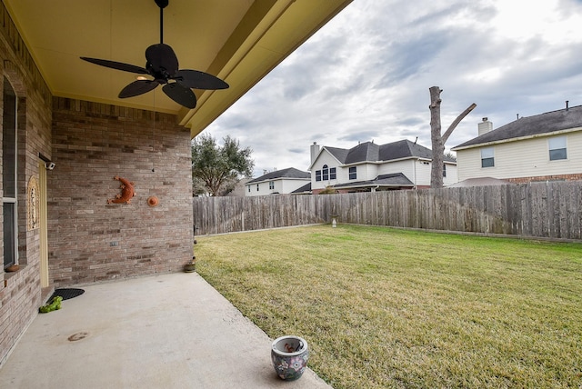 view of yard with ceiling fan and a patio area