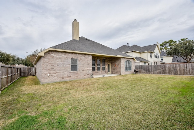 rear view of property featuring a lawn