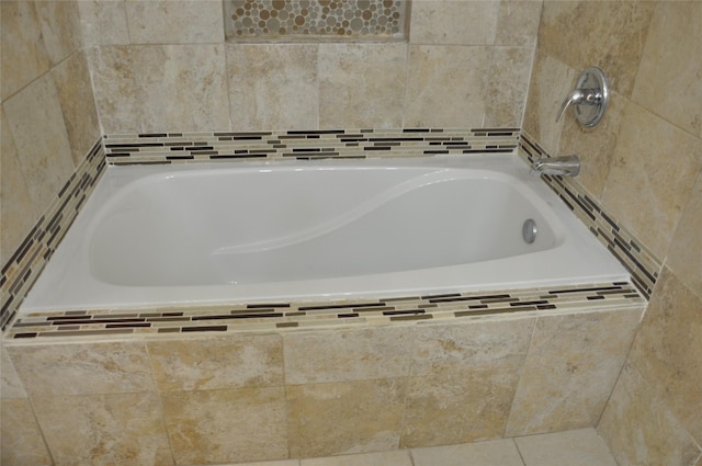 bathroom featuring tile patterned flooring and a bathtub