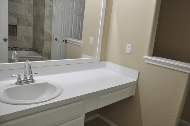 bathroom with vanity and a tub